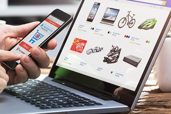 A person comparing prices for an electronics item on a phone, demonstrating the use of price comparison tools to find the best deal