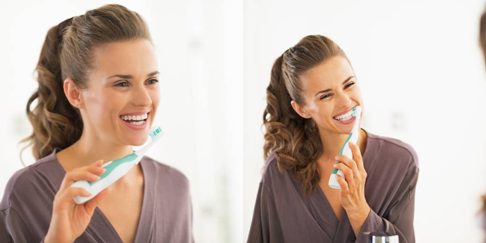 A person using a Philips Sonicare toothbrush, showcasing a personal care savings deal