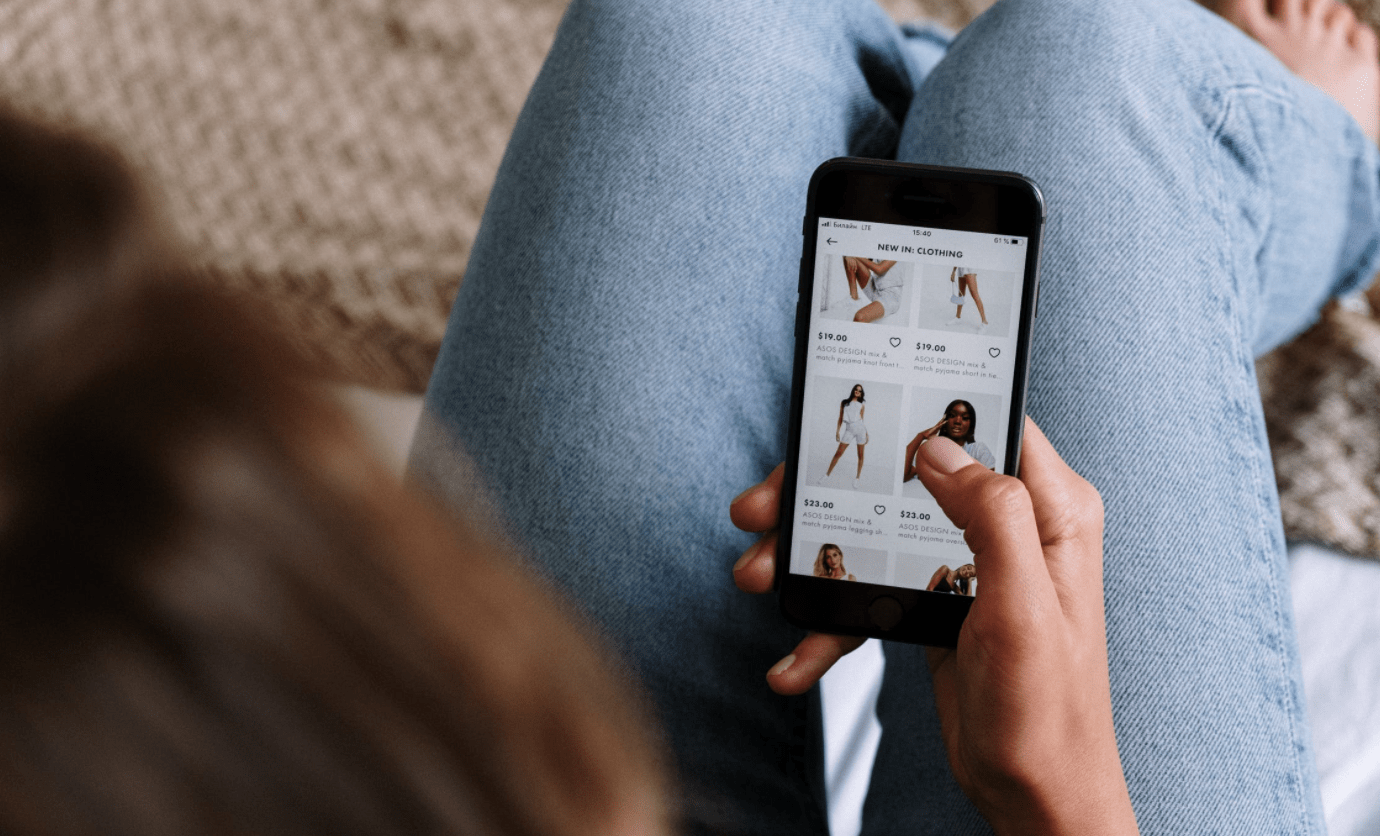 Person using a smartphone to find online shopping deals and discounts