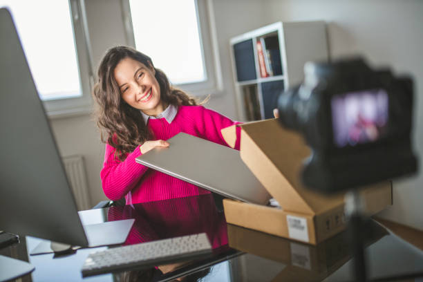 A happy shopper unboxes a new laptop, a perfect example of a successful holiday tech deal